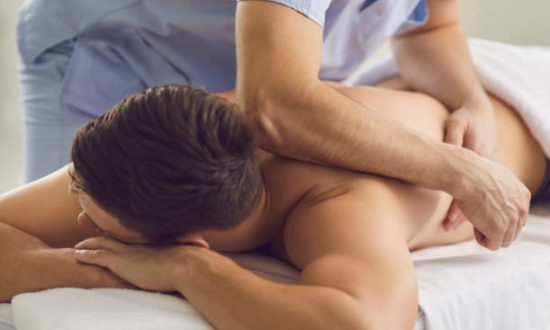 remedial-massage (2) Close-up of relaxed young man enjoying remedial body massage done by professional masseur in spa salon or wellness center. Therapeutic treatment of injuries, manual therapy, rehabilitation